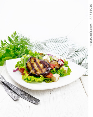 Salad of eggplant with cheese and tomatoes on table 82755930