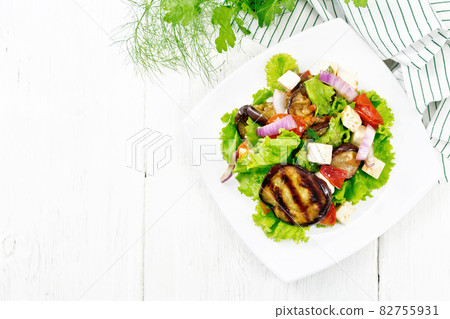 Salad of eggplant with cheese and tomatoes on light board top 82755931