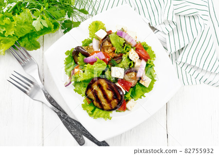 Salad of eggplant with cheese and tomatoes on board top 82755932