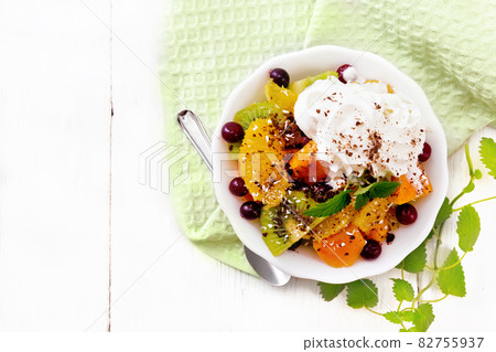 Salad fruit with cranberries in bowl on board top 82755937
