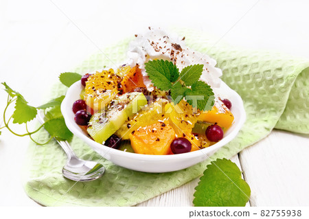 Salad fruit with cranberries in bowl on board 82755938
