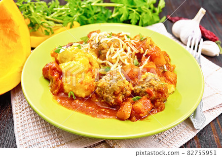 Porridge corn with meat and vegetables in plate on dark board 82755951