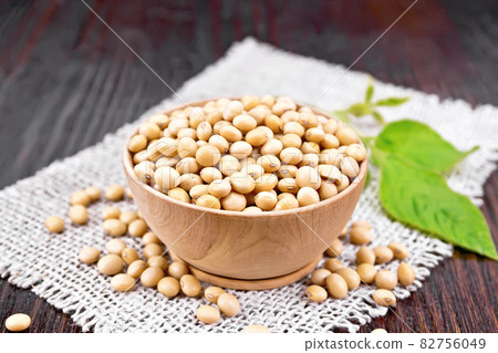 Soybeans in wooden bowl with leaf on dark board Soybeans in wooden bowl with leaf on dark board 82756049