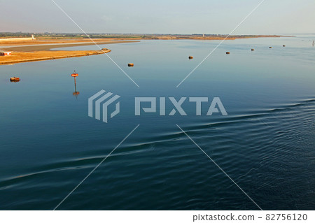 View of the desert coast from the boat while sailing on the Suez Canal View of the desert coast from the boat while sailing on the Suez Canal 82756120