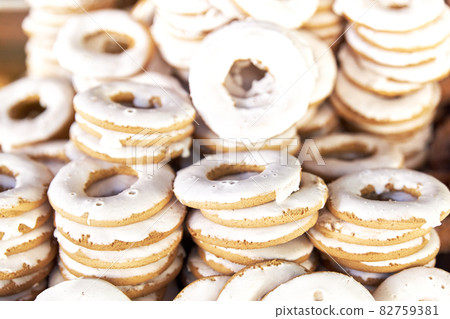 Group of sweet doughnuts in a stall of a store for sale on the street. Food concept Group of sweet doughnuts in a stall of a store for sale on the street. Food concept 82759381