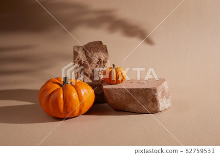 Autumn background podium display with pumpkins on biege background. Cosmetic, beauty product promotion autumn pedestal with shadows Autumn background podium display with pumpkins on biege background. Cosmetic, beauty product promotion autumn pedestal with shadows 82759531