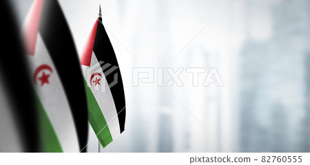 Small flags of Sahrawi on a blurry background of the city Small flags of Sahrawi on a blurry background of the city 82760555