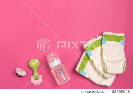 Baby care accessories and diapers on pink background. Top view Baby care accessories and diapers on pink background. Top view 82760648