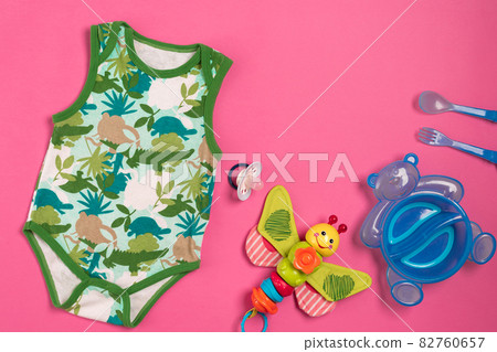 Baby clothes and accessories on pink background. Top view Baby clothes and accessories on pink background. Top view 82760657