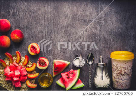 Ingredients for oatmeal on dark wooden table. Concept of healthy food. Top view, copy space. Toned 82760760
