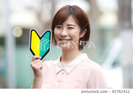 Female employee with a beginner mark 82762422