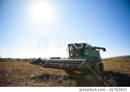 Harvester in a field for harvesting in autumn. 82762607