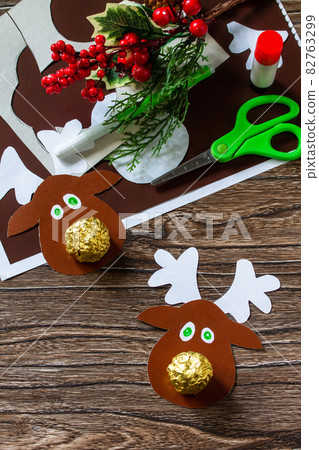 Funny Gift with candy Christmas deer. Handmade. Children's creativity project, crafts, crafts for kids. Funny Gift with candy Christmas deer. Handmade. Children's creativity project, crafts, crafts for kids. 82763299
