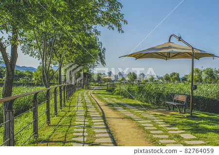 Park walkway with awnings and benches Park walkway with awnings and benches 82764059