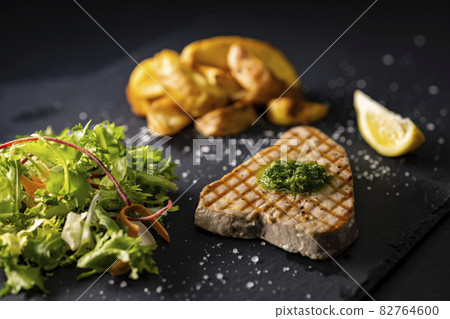 tuna steak with salad and spicy potatoes tuna steak with salad and spicy potatoes 82764600