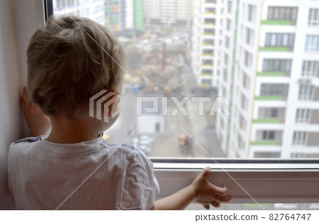 Beautiful baby boy with child face posing photographer near window Beautiful baby boy with child face posing photographer near window 82764747
