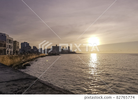 Sunset over Malecon and Atlantic Ocean with visible sun rays - Havana, Cuba  82765774
