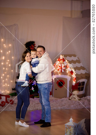 Happy family portrait on Christmas, mother, father and child at home. Happy family portrait on Christmas, mother, father and child at home. 82765880