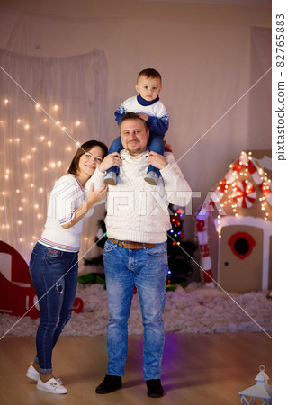 Happy family mother father and baby at christmas tree at home. Happy family mother father and baby at christmas tree at home. 82765883