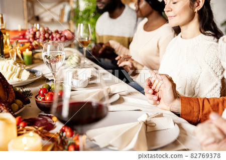 Happy family celebrate Thanksgiving day, sitting at table with roasted turkey and holiday traditional food, dishes. 82769378