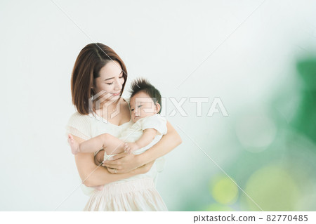 Mom holding a baby Mom holding a baby 82770485