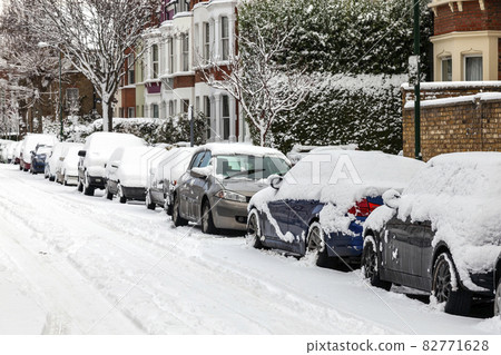 street winter cityscape with snow terraced houses and frozen cars after a blizzard snowfall, 82771628