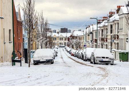 street winter cityscape with snow terraced houses and frozen cars 82771846