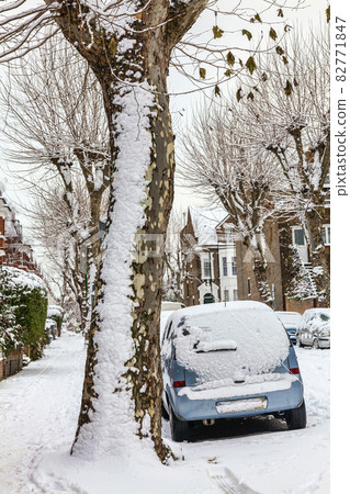 street winter cityscape with snow terraced houses and frozen cars 82771847