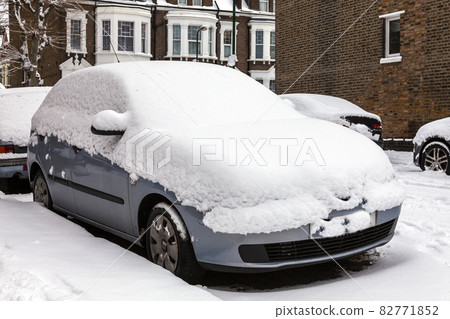 street winter cityscape with snow covered frozen cars after a blizzard snowfall street winter cityscape with snow covered frozen cars after a blizzard snowfall 82771852