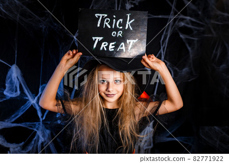 Little girl in Halloween costume trick or treating. Halloween decoration Little girl in Halloween costume trick or treating. Halloween decoration 82771922