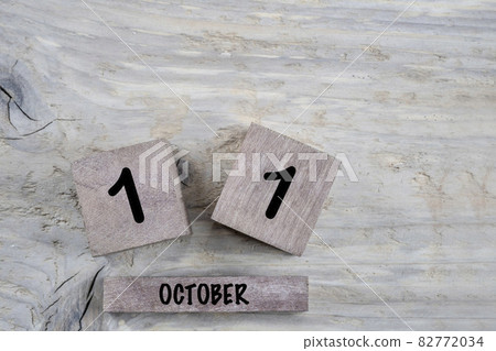 cube calendar for october on wooden background with copy space 82772034