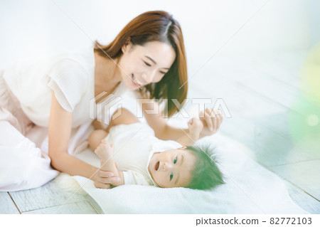 Mom and baby playing indoors 82772103