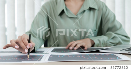 Hand of businesswoman are planning business investments related to shares By analyzing and calculating the stock market for marketing profits Hand of businesswoman are planning business investments related to shares By analyzing and calculating the stock market for marketing profits 82772810