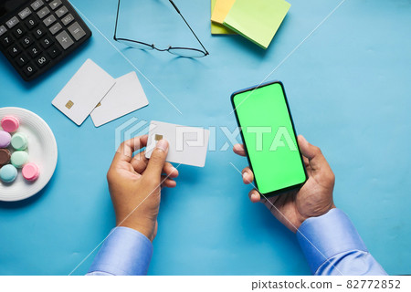 Man hand holding credit card and using smart phone shopping online Man hand holding credit card and using smart phone shopping online 82772852