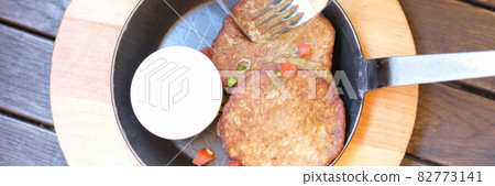 Taste cooked pancakes in pan with sour cream closeup Taste cooked pancakes in pan with sour cream closeup 82773141
