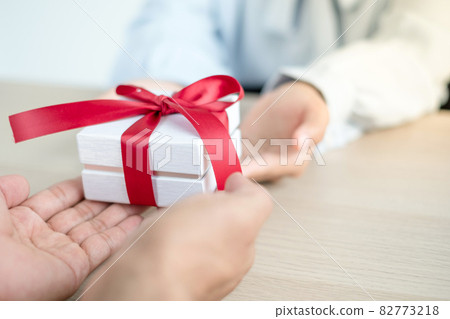 A hand holding a gift box Glad to be the giver of surprise with excitement, joy on the holidays, Christmas, birthdays, or Valentine's Day concept A hand holding a gift box Glad to be the giver of surprise with excitement, joy on the holidays, Christmas, birthdays, or Valentine's Day concept 82773218