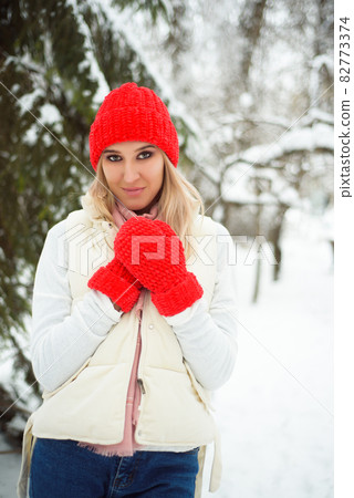 Happy winter time walking on street. Enjoying snowfall, expressing positivity, smiling to camera 82773374