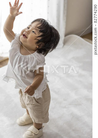 Standing baby wearing baby shoes (1 year and 2 months old, girl, Japanese) 82774290