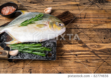 Raw fish Sunfish or pompano on a wooden board. wooden background. Top view. Copy space Raw fish Sunfish or pompano on a wooden board. wooden background. Top view. Copy space 82774656