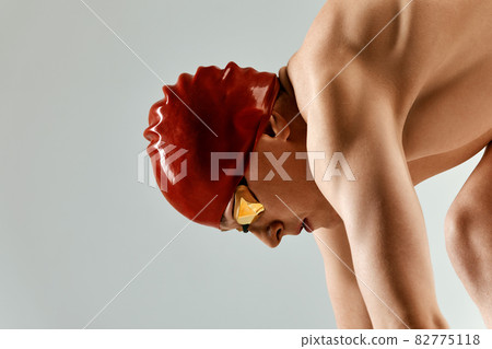 Portrait of a swimmer who is preparing for a jump. The concept of swimming and water games. Front view. Mixed media Portrait of a swimmer who is preparing for a jump. The concept of swimming and water games. Front view. Mixed media 82775118