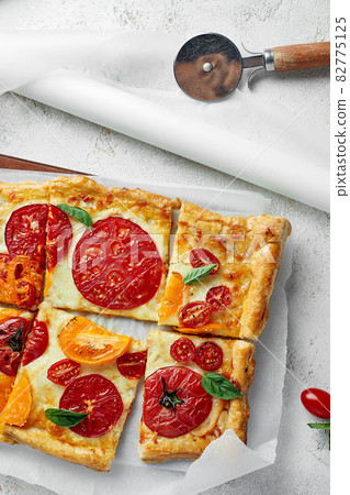 Delicious homemade square pizza with vegetables on white Delicious homemade square pizza with vegetables on white 82775125