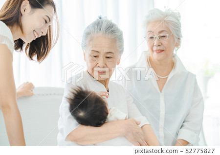 Senior women hugging babies and women watching over 82775827