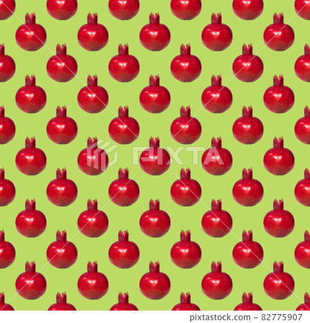 Pattern of a ripe red pomegranate on green background, Creative Food Concept, Flatlay Pattern of a ripe red pomegranate on green background, Creative Food Concept, Flatlay 82775907