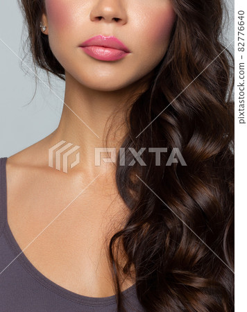 Cosmetics, makeup and trends. Bright lip gloss and lipstick on lips. Closeup of beautiful female mouth with natural lip makeup. Beautiful part of female face. Perfect clean skin in natural light Cosmetics, makeup and trends. Bright lip gloss and lipstick on lips. Closeup of beautiful female mouth with natural lip makeup. Beautiful part of female face. Perfect clean skin in natural light 82776640