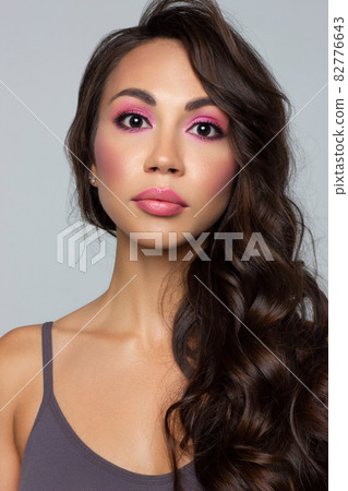 Beautiful brunet model woman face with brown eyes and perfect make-up . Portrait of beauty young brunet girl with pink lips. Female face with clear skin close-up. Skincare Beautiful brunet model woman face with brown eyes and perfect make-up . Portrait of beauty young brunet girl with pink lips. Female face with clear skin close-up. Skincare 82776643
