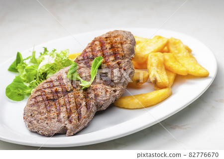 beef steak with homemade french fries and vegetable salad 82776670