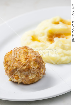 meat ball with cheese served with mashed potatoes 82776674