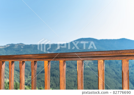 Wooden balcony railing in the mountains Wooden balcony railing in the mountains 82776690