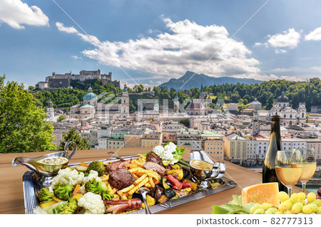 Salzburg city with gastronomic experience of typical Austrian food and wine against downtown in Austria 82777313