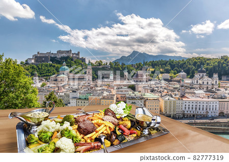 Salzburg city with gastronomic experience of typical Austrian food against downtown in Austria 82777319